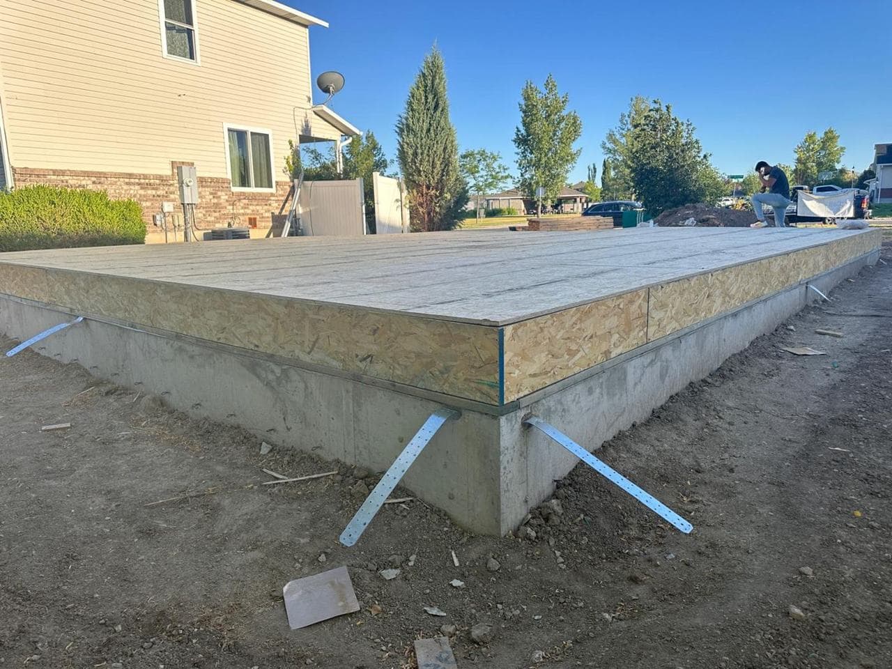 Long side of the new foundation and subfloor with hold-down straps in place