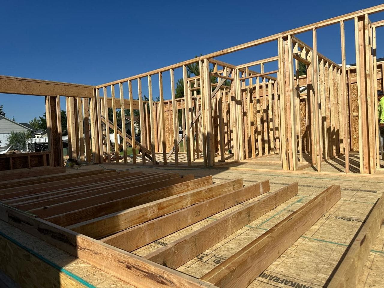 Interior wall framing and floor joists looking across the new addition
