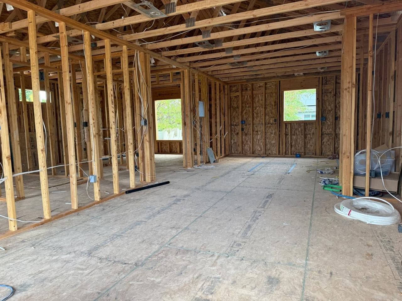 Interior of the addition with wiring run through the wall studs and roof trusses
