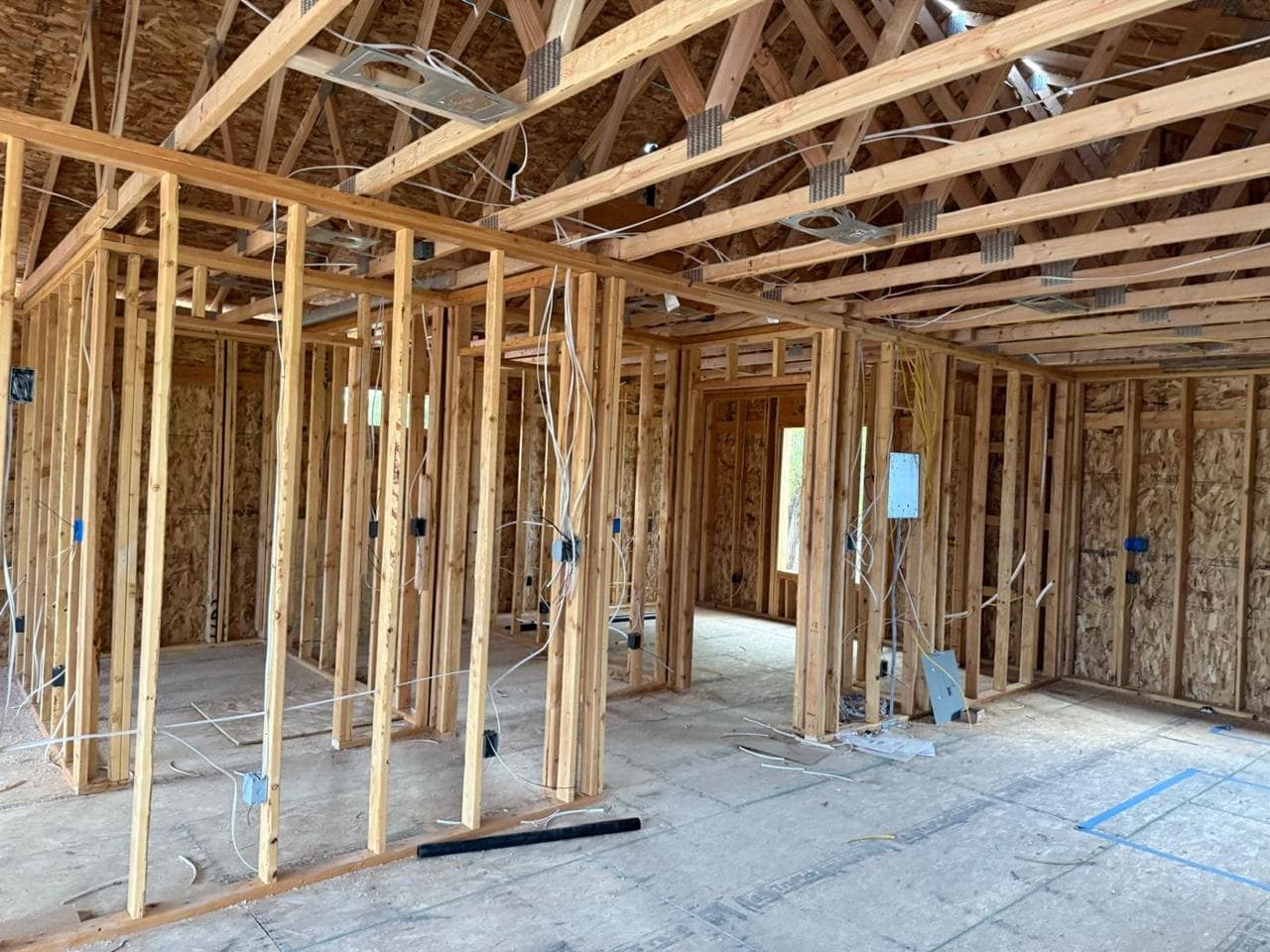 Framed interior walls and doorways with electrical wiring and boxes installed