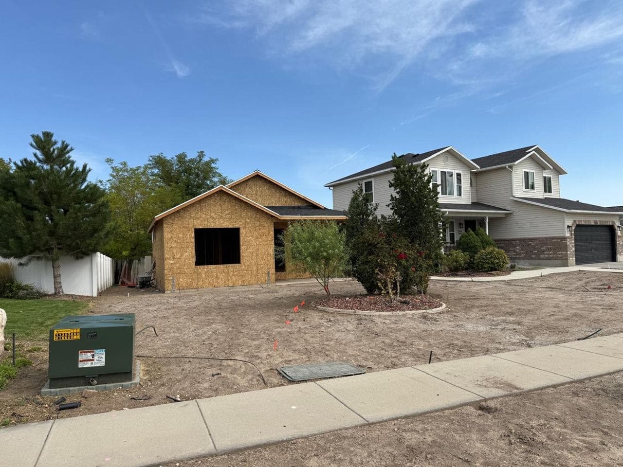 The addition beside the existing two-story home, before the weather barrier