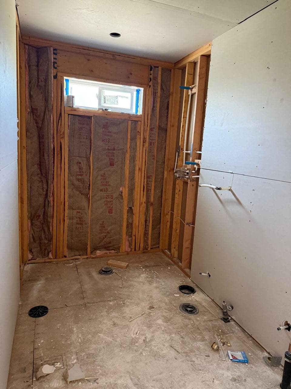 Shower alcove framed with insulation and drywall going up