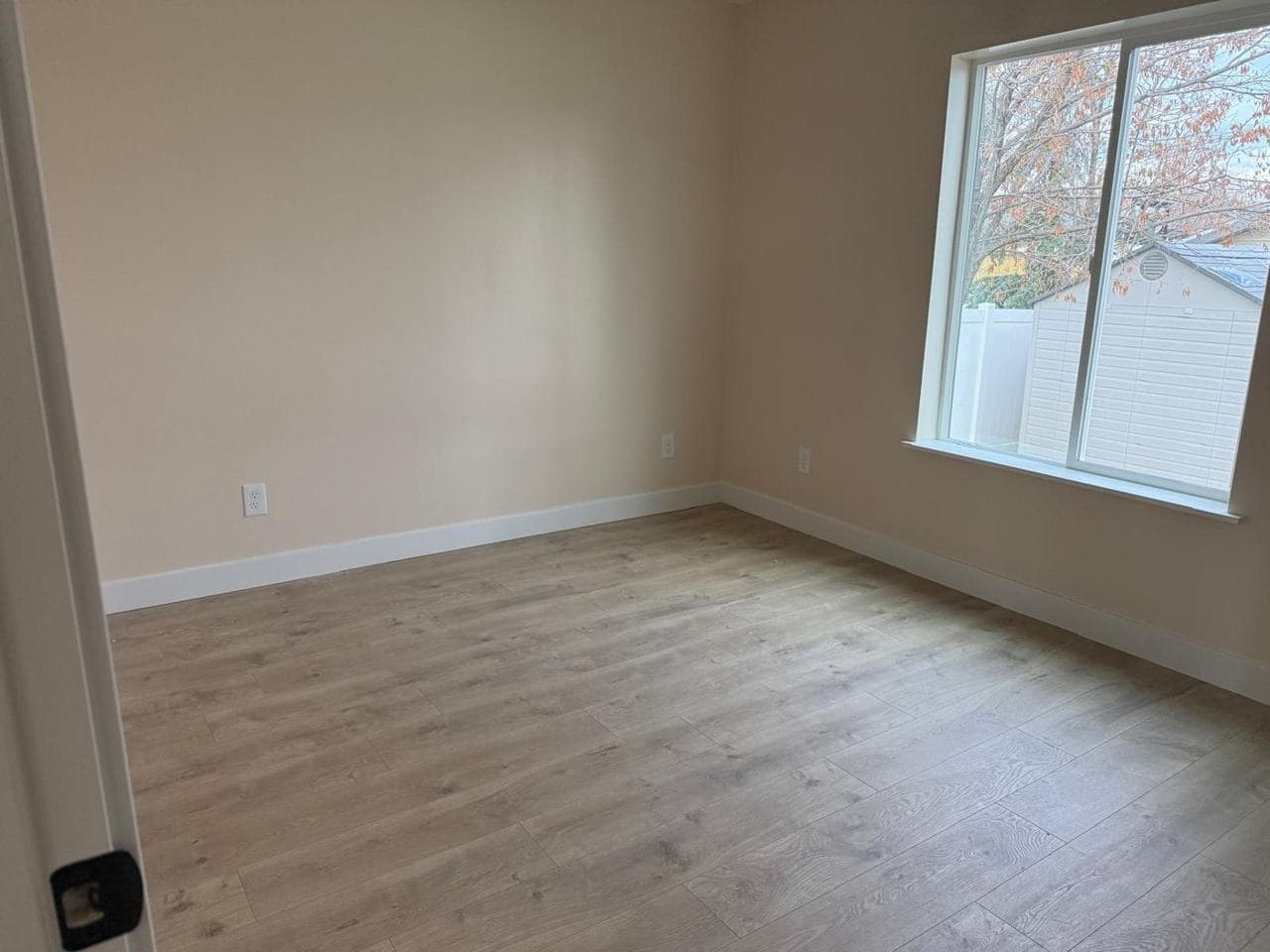 Living area with wood-look flooring and a large picture window