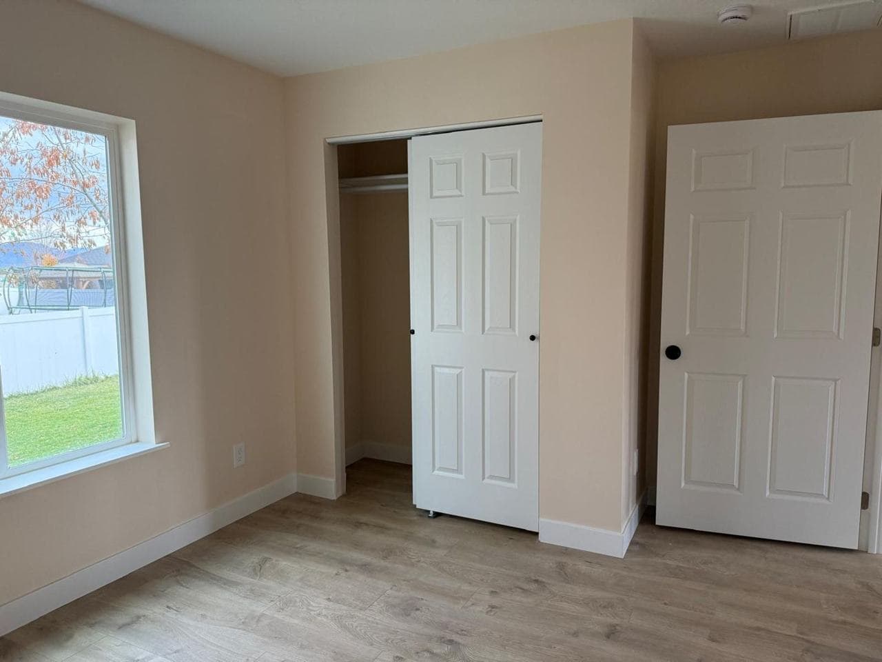 Bedroom with a closet, interior doors and a window
